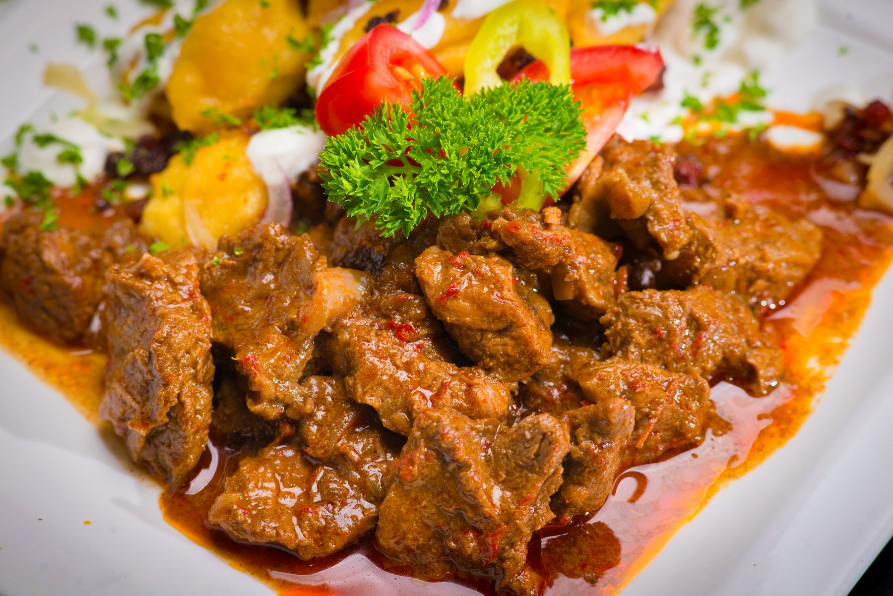 Plate of saucy beef stew with vegetables